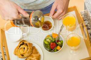 Man preparing a breakfast tray