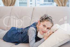 Little girl lying on the couch with teddy