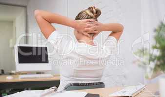 Rear view of businesswoman at office desk
