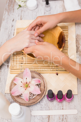 Nail technician giving customer a manicure