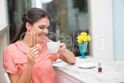 Pretty brunette having a coffee