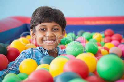 Cute boy smiling in ball pool