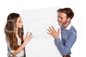 Happy young couple with blank board