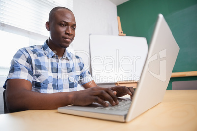 Cheerful creative businessman working on computer