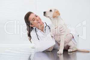 Smiling veterinarian examining a cute dog