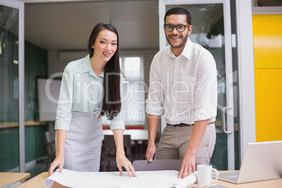 Casual architecture team working together at desk