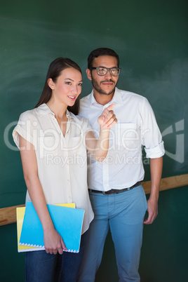 Businesswoman showing something to male colleague