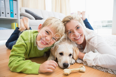 Happy mother and son with puppy