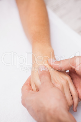 Manicurist washing customers hand