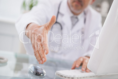 Happy doctor handshake at his patient