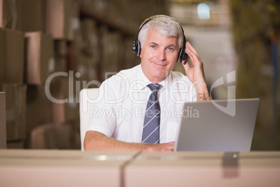 Warehouse manager using laptop