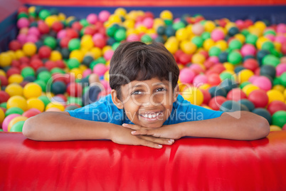 Cute boy smiling in ball pool