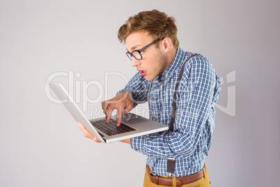 Geeky businessman using his laptop