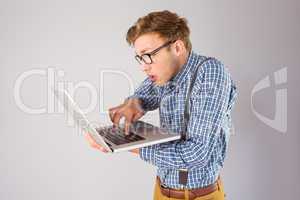 Geeky businessman using his laptop