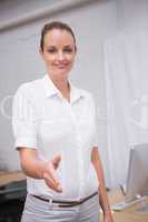 Businesswoman offering handshake at office