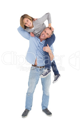 Smiling man carrying son on his shoulders