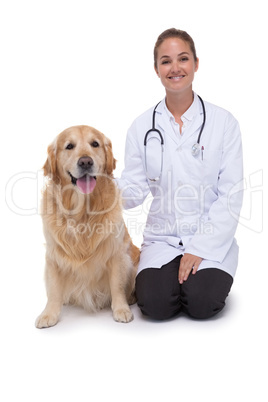 Vet kneeling beside a dog