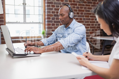 Casual designer working at his desk