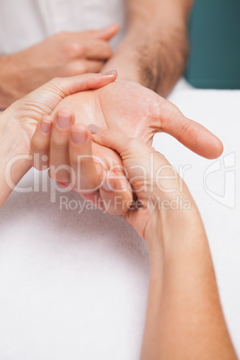 Manicurist massaging a customers hand