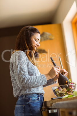 Cute brunette making a salad