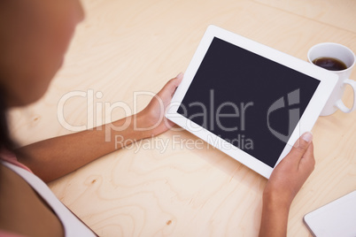 Close up of a tablet pc and a mug of coffee