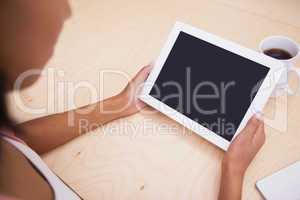 Close up of a tablet pc and a mug of coffee