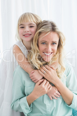 Mother sitting on the couch with her daughter