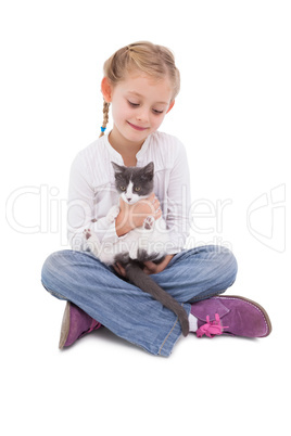 Little girl sitting with cat in her arms