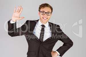 Young geeky businessman smiling at camera