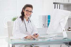 Smiling vet writing and using computer