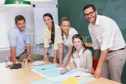 Team of architects studying blueprints during a meeting