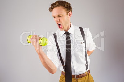 Geeky businessman lifting a dumbbell