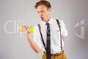 Geeky businessman lifting a dumbbell