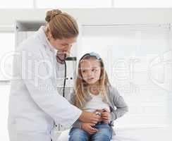 Doctor checking a young patients stomach
