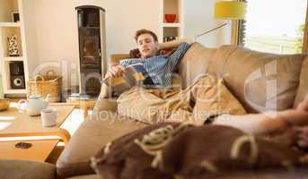 Young man reading on his couch