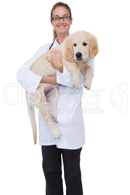 Smiling vet holding a puppy