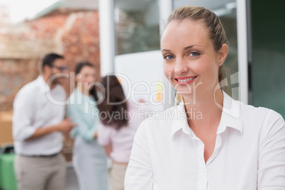 Casual blonde businesswoman smiling at camera