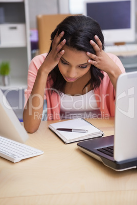 Anxious businesswoman sitting at her desk