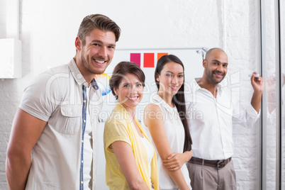 Smiling business people looking at camera during a meeting