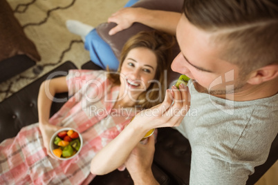 Cute couple relaxing on couch at breakfast