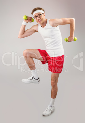 Geeky hipster posing in sportswear with dumbbells