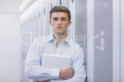 Portrait of a confident technician holding a laptop