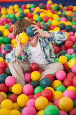 Cute boy smiling in ball pool