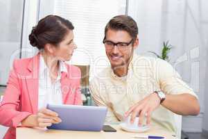 Business colleagues holding coffee cup and digital tablet