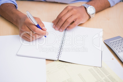 Hand writing documents at desk