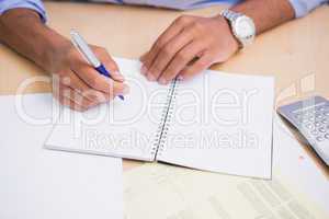 Hand writing documents at desk