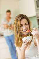 Woman eating fruit salad at breakfast