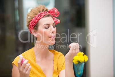 Pretty hipster blowing on her wet nails