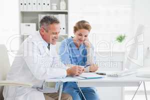 Doctor and nurse reading over medical notes