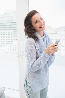 Pretty brunette on the phone by the window